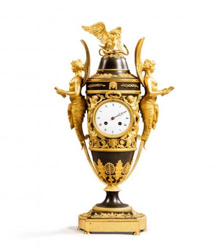 An Empire patined and gilt bronze mantel clock