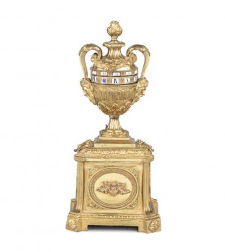 A Louis XVI style cercles tournants urn clock