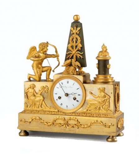 AN EMPIRE PATINATED GILT BRONZE CLOCK