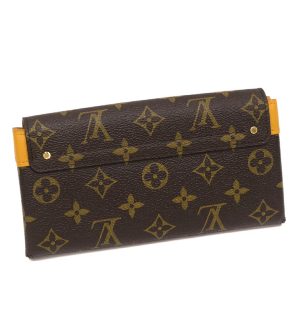 LOUIS VUITTON ELYSEE MONOGRAM WALLET, with gold tone clasp at the front and  red partitioned leather interior with a central zippered pocket and twelve  card slot panels, with dust bag, box and